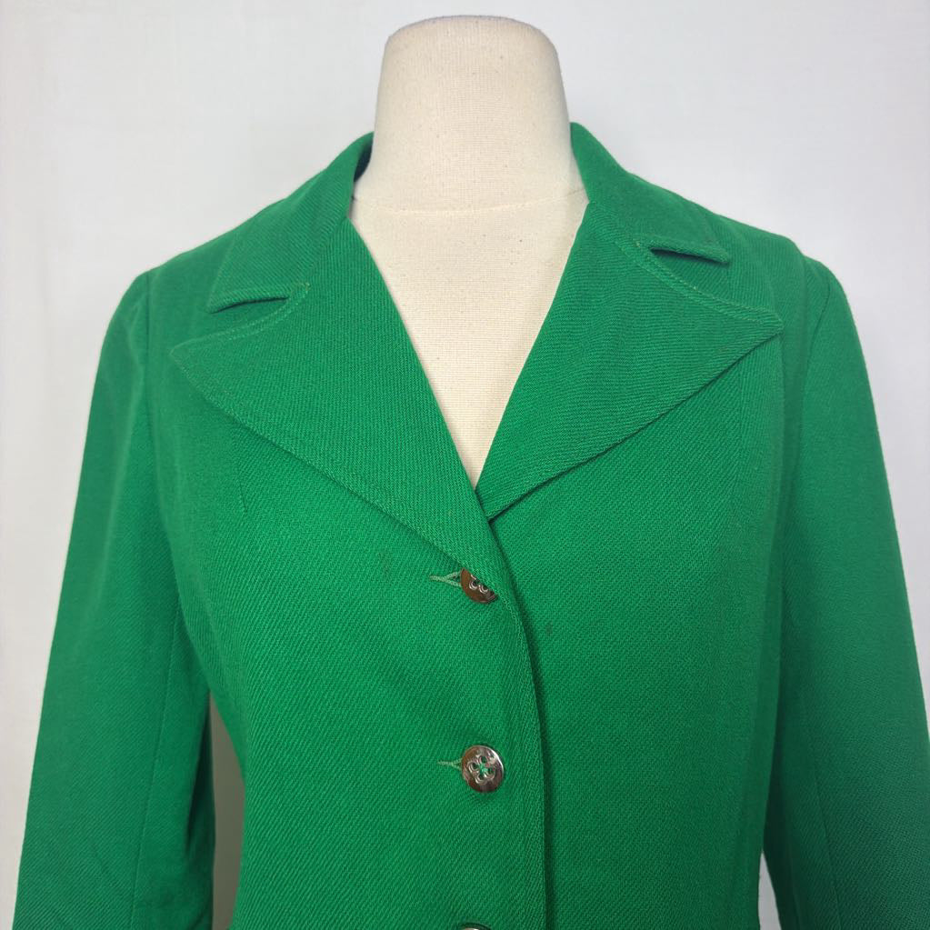 A bright green textured jacket displayed on a cream-colored mannequin torso against a plain white background.