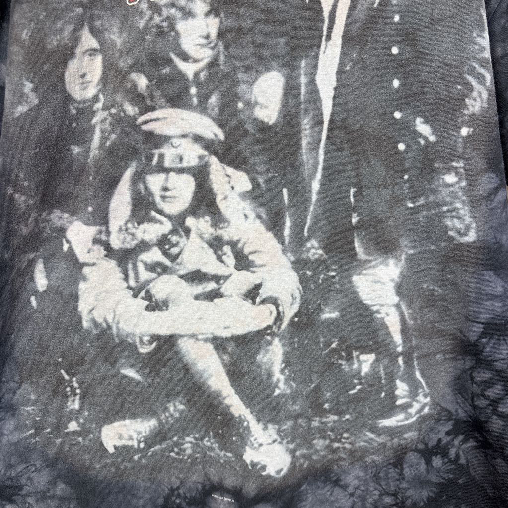 A dark gray tie-dye short sleeve t-shirt with an image of Led Zeppelin on it. The tee hangs on a wooden rack against a white background.