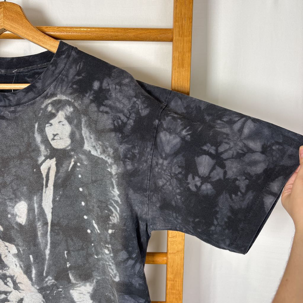 A dark gray tie-dye short sleeve t-shirt with an image of Led Zeppelin on it. The tee hangs on a wooden rack against a white background.