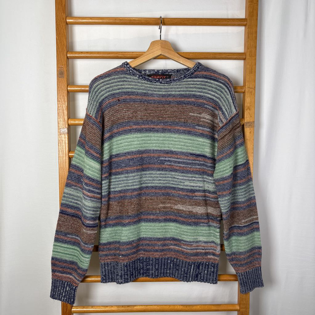 A blue, green, and brown striped knitted long sleeve sweater hanging on a wooden rack against a white background.