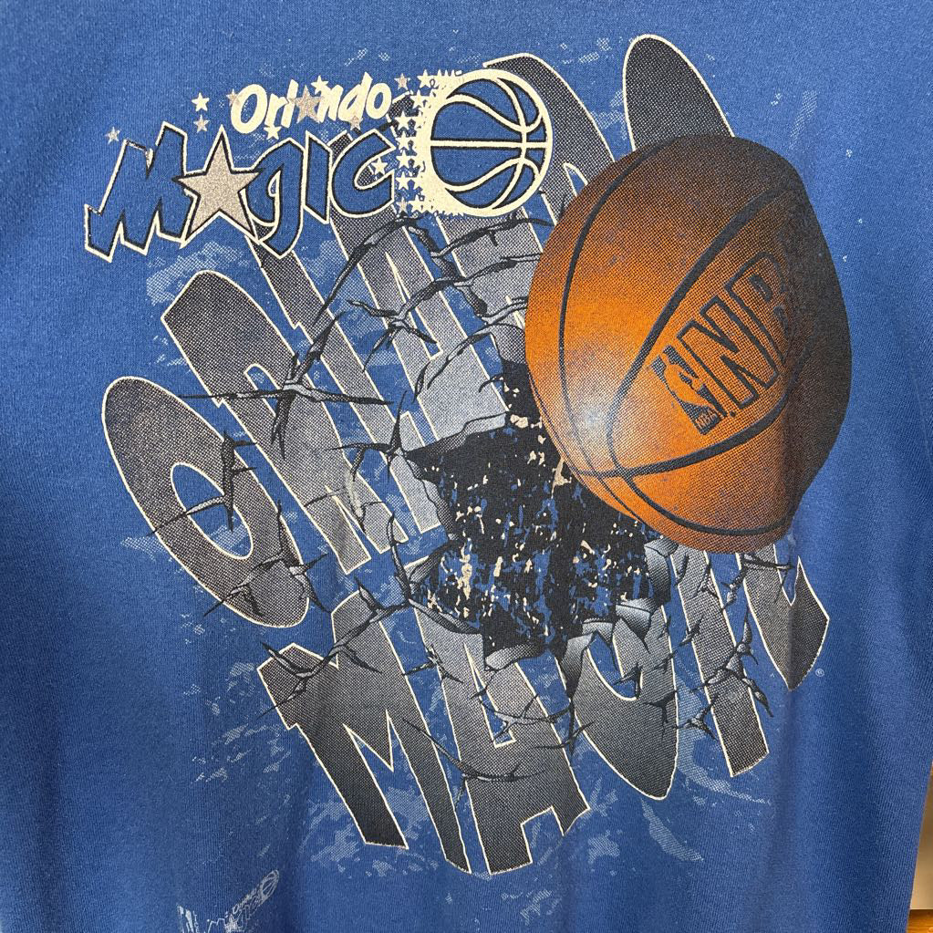 A blue sweatshirt with Orlando Magic branding and the image of a basketball on the front. 