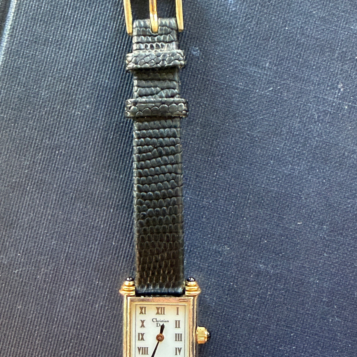 Showing the band of the Christian Dior tank watch