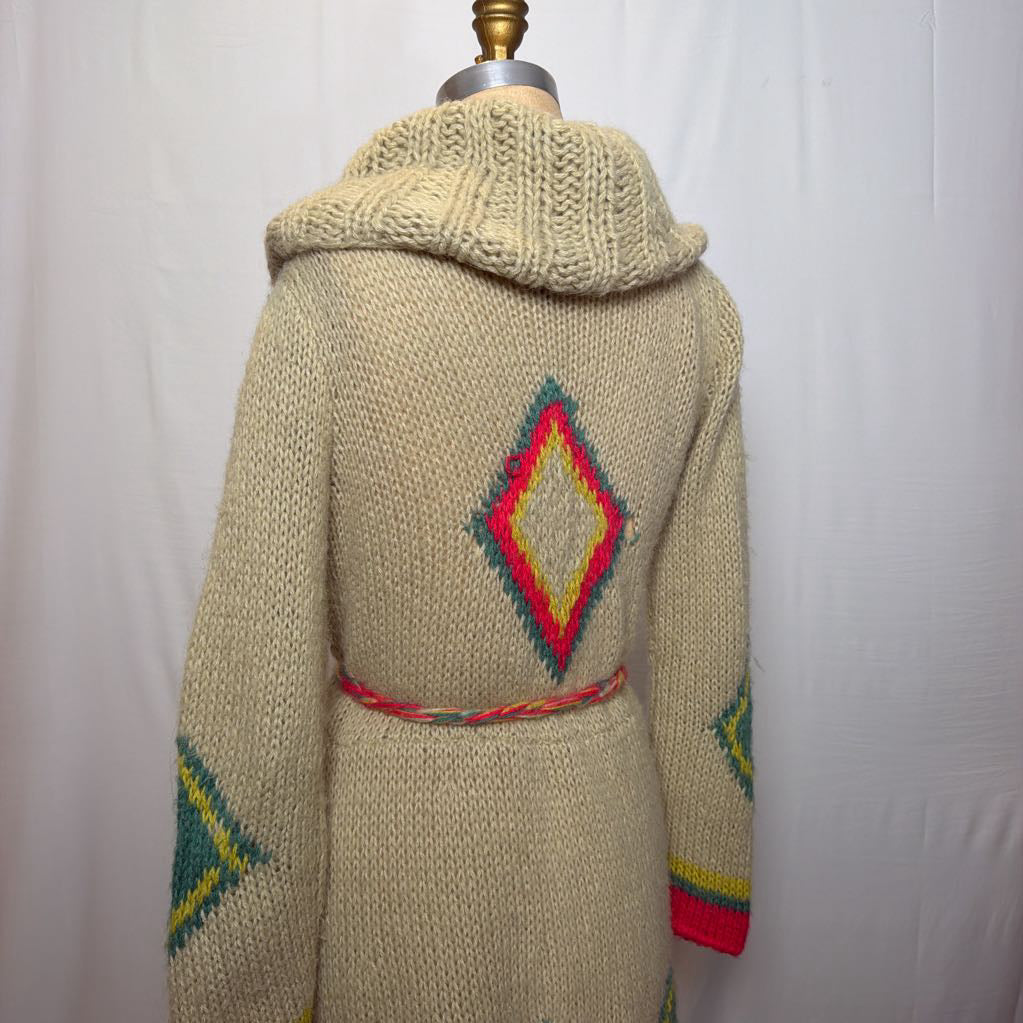 A tan belted knit sweater hoodie on a mannequin in front of a white wall.