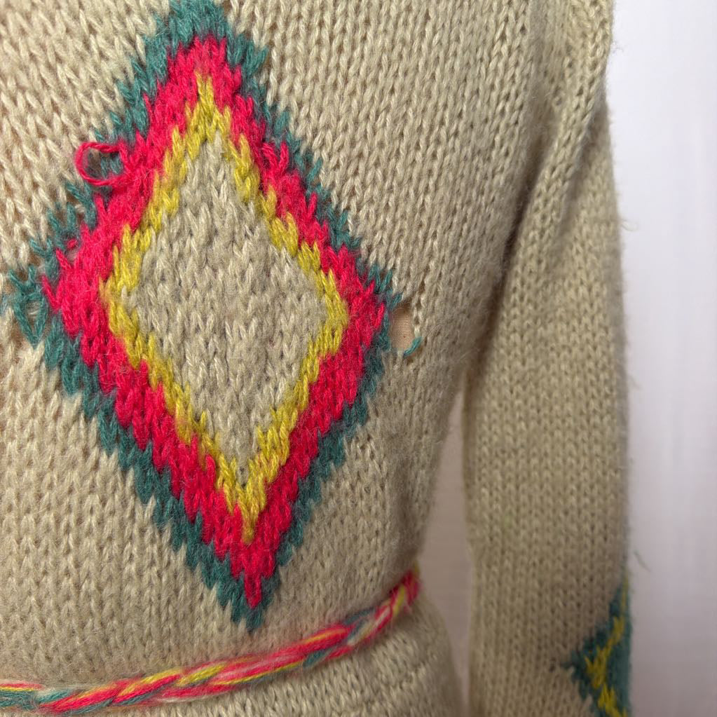 A tan belted knit sweater hoodie on a mannequin in front of a white wall.
