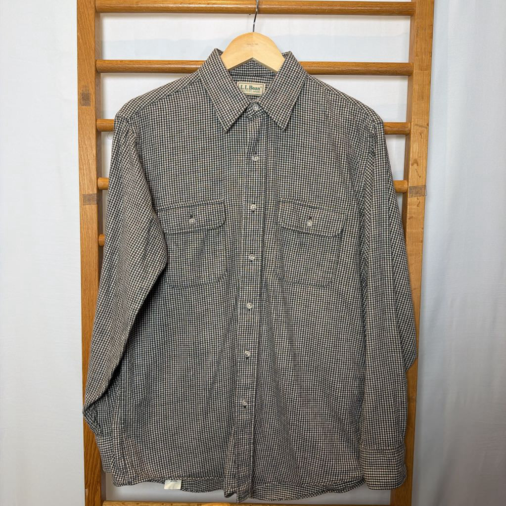 A button-up shirt on a wooden rack.