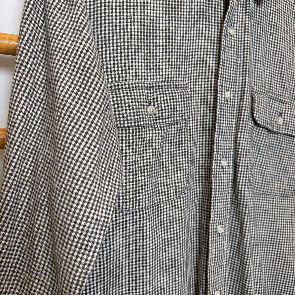A button-up shirt on a wooden rack.