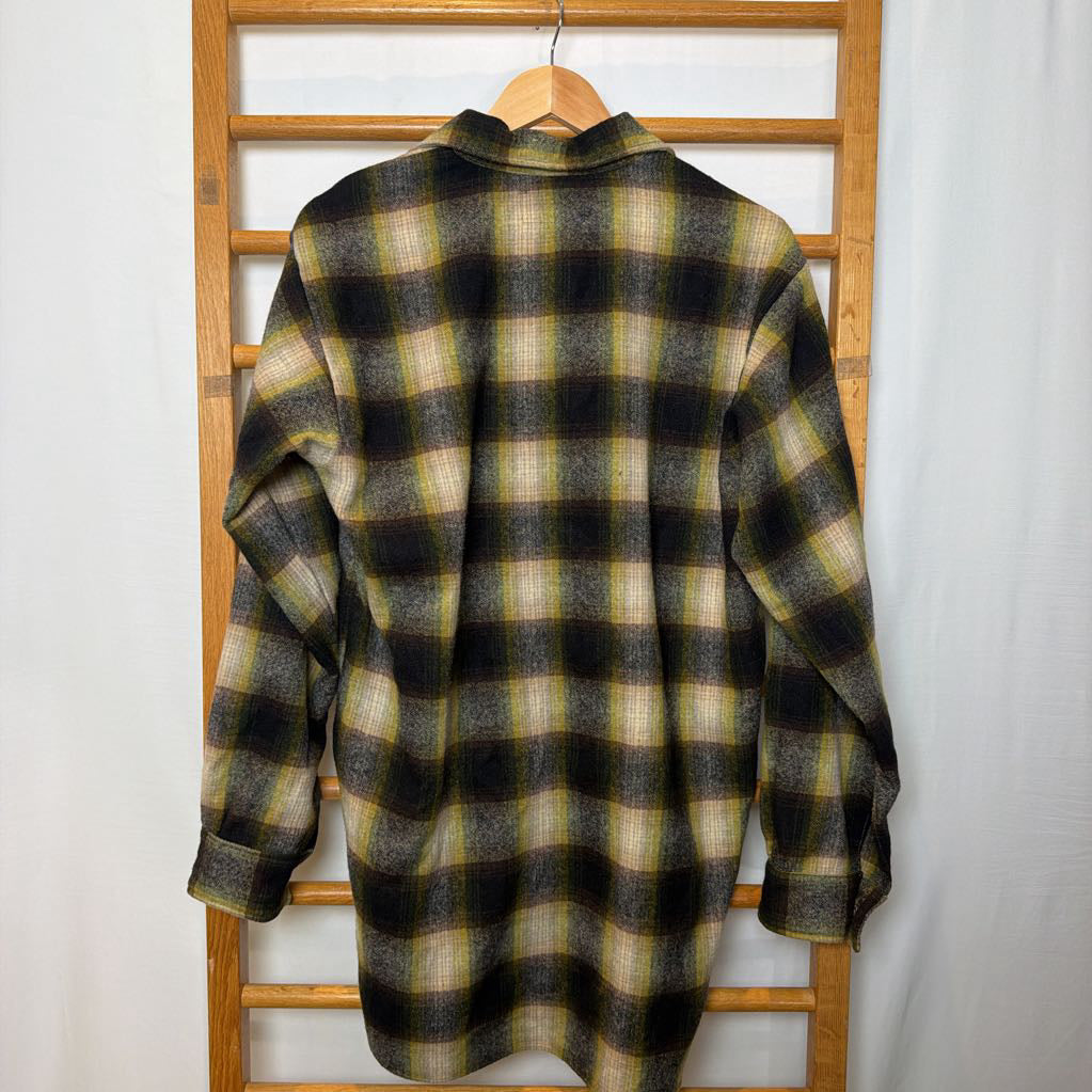 A green ombre plaid button-up shirt on a wooden rack. 
