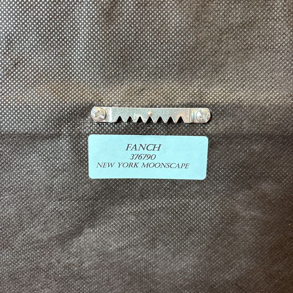 The back of an artwork with the artist's name and relating information of the work. 