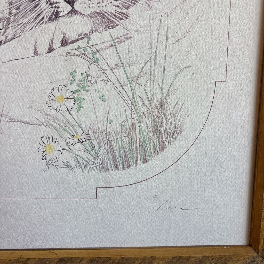 A white artwork of a tiger and cubs in a thick wooden frame. 