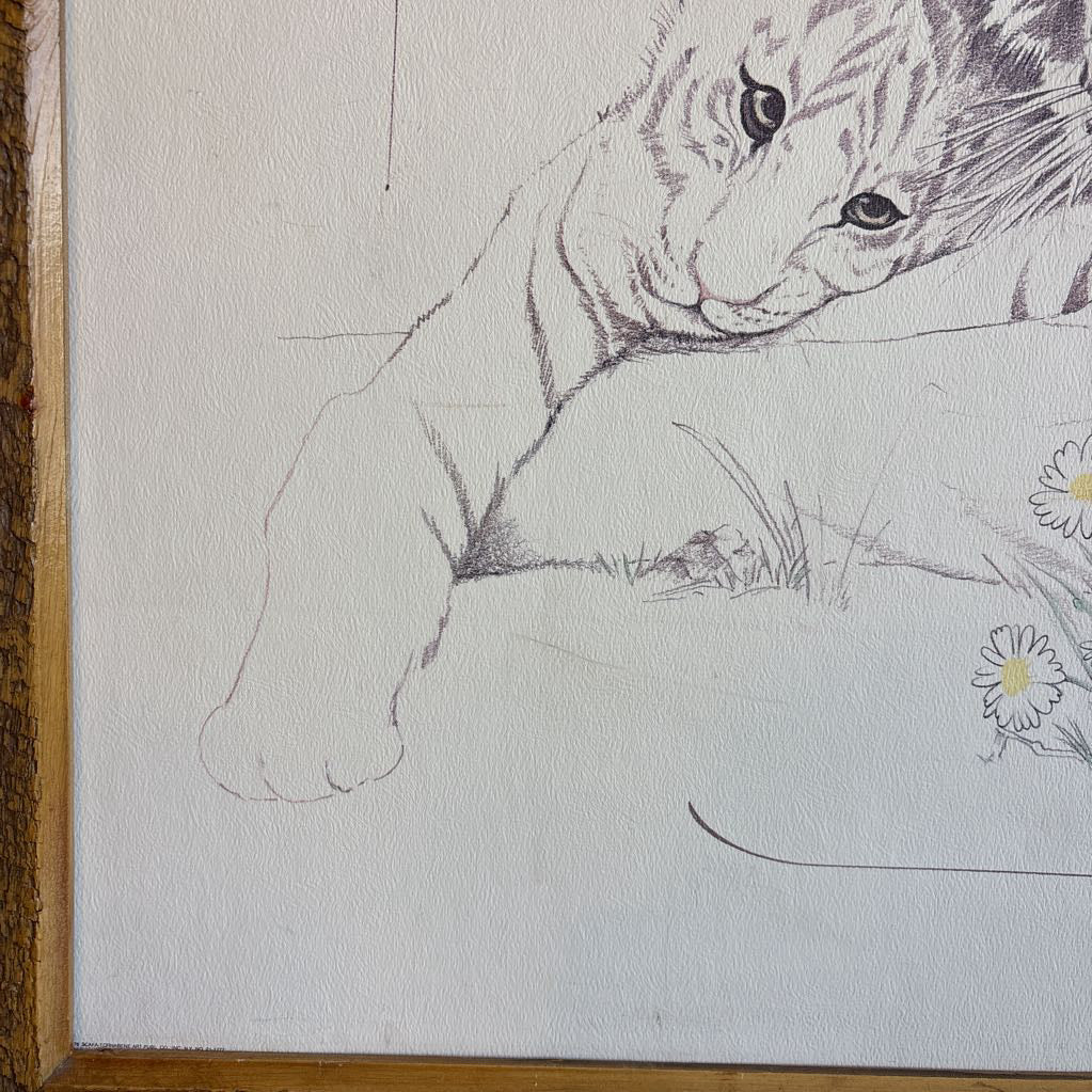 A white artwork of a tiger and cubs in a thick wooden frame. 